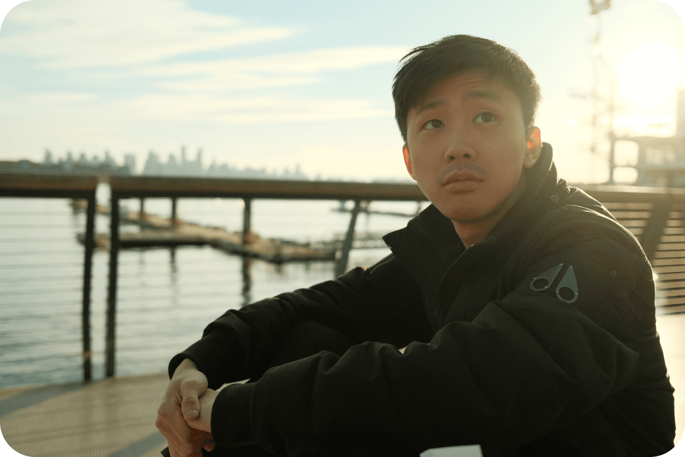 a pleasant picture of Darell sitting by a pier